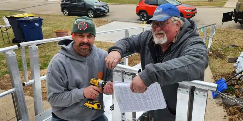 Two male Habitat volunteers working on a ramp as a home revitalization project