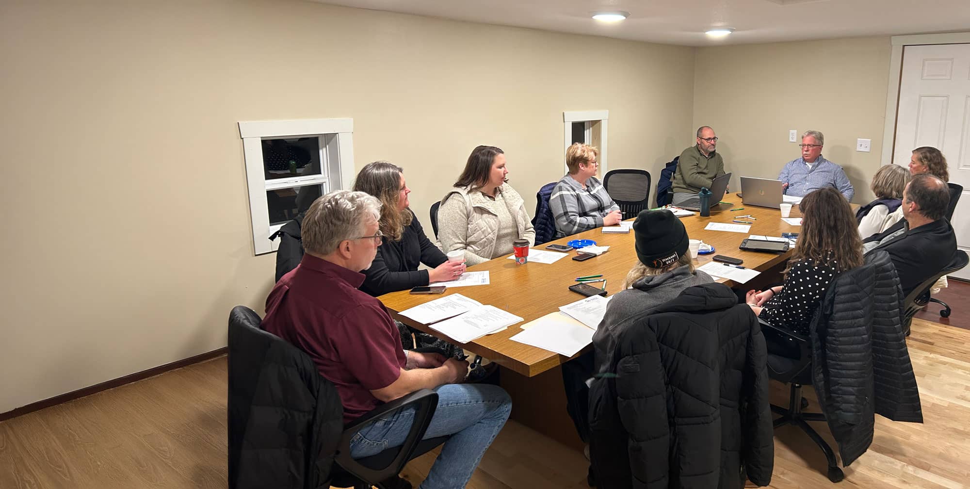 The GCHFH Board sitting at a long table along with the Executive Director