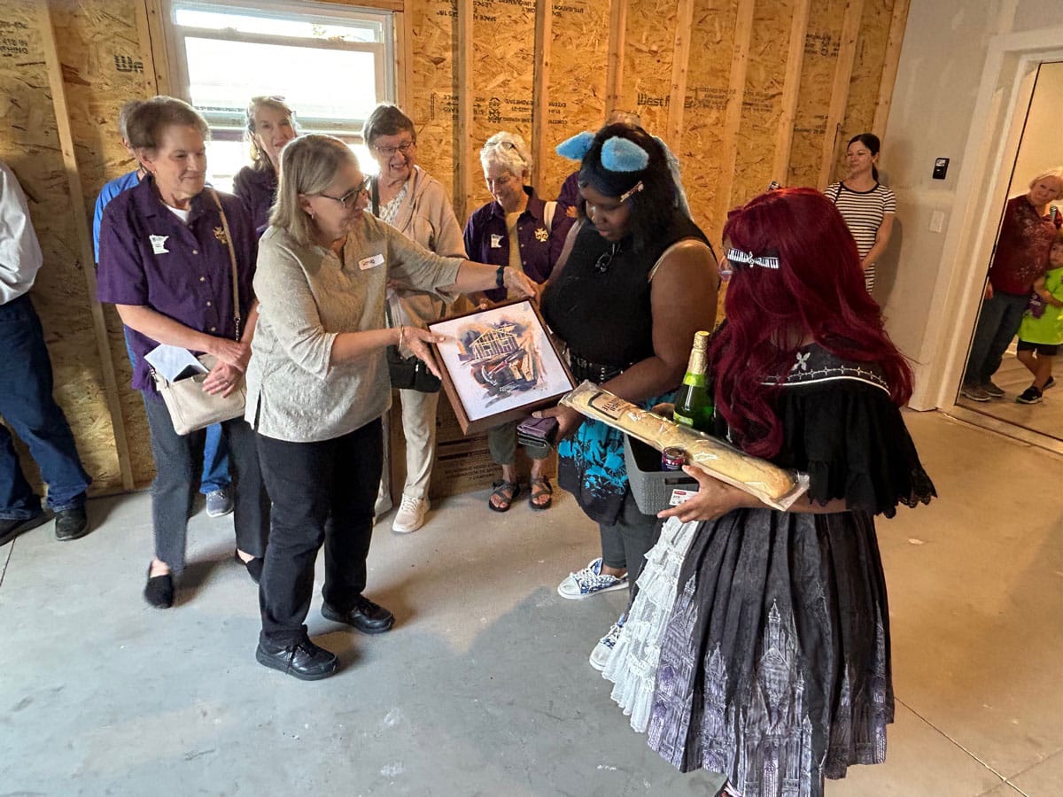 Two new homeowners receive Habitat wall art for their new home