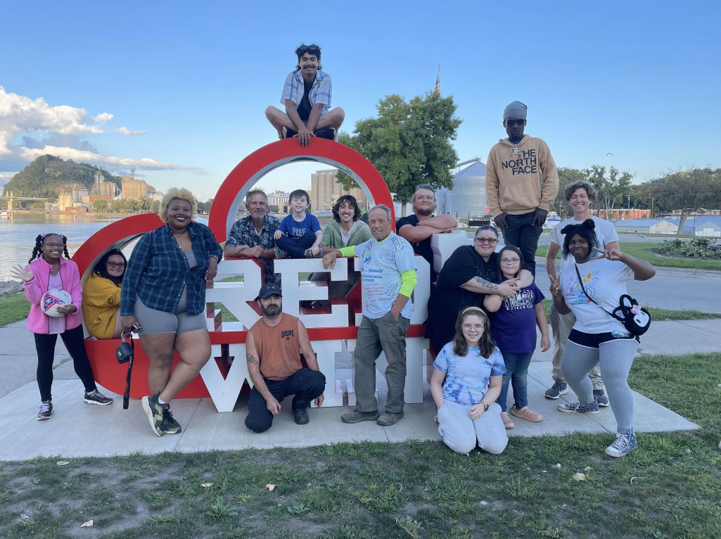 AmeriCorps Maple 6 Volunteer Team posing in front of the Heart Red Wing by the Mississippi River