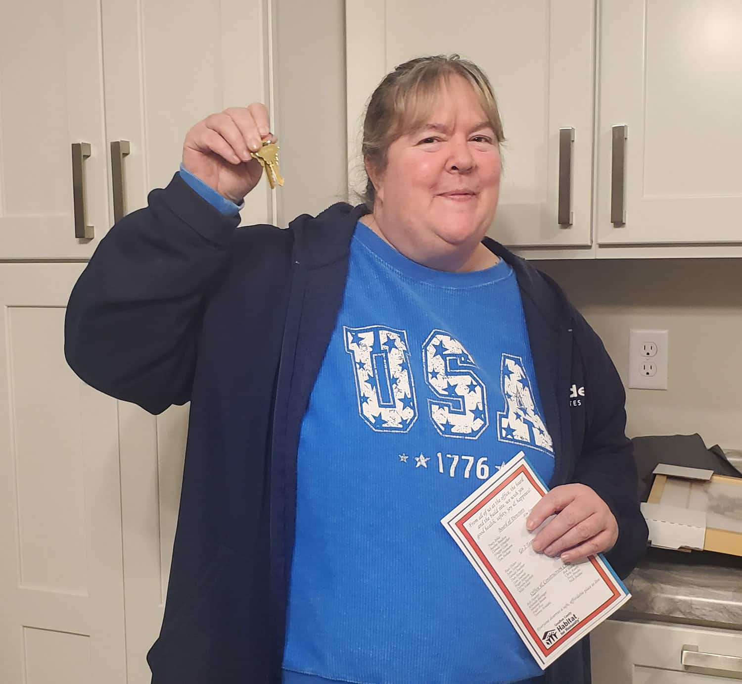 Homeowner Denise with the keys to her home