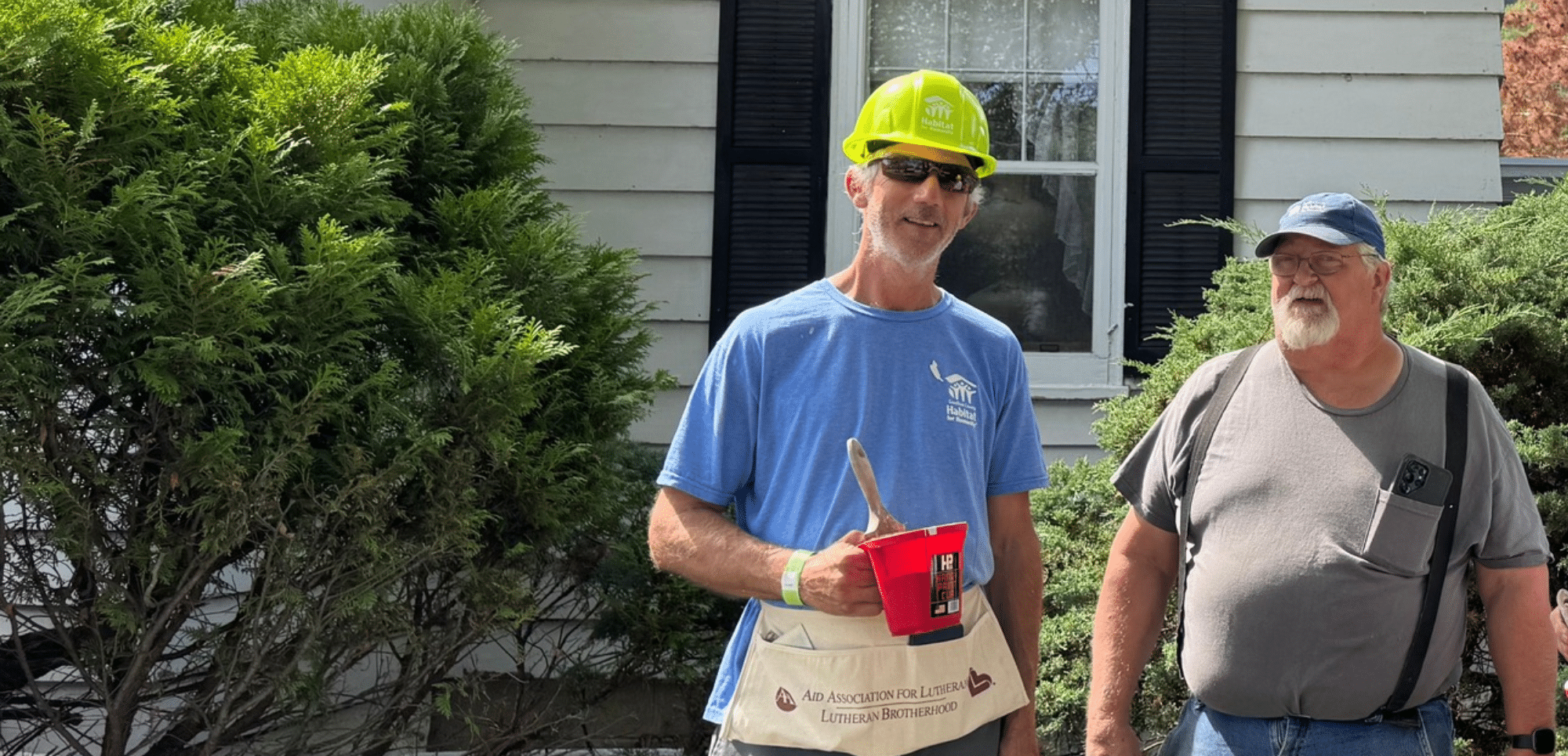 Habitat Construction Staff Painting a House