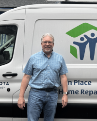 Joe White (From Lake City) standing in front of the Goodhue County Habitat for Humanity van.