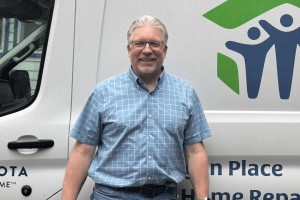 Joe White (From Lake City) standing in front of the Goodhue County Habitat for Humanity van.
