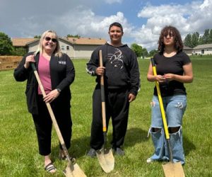 Future homeowner and her kids pose with shovels at the groundbreaking at their new home