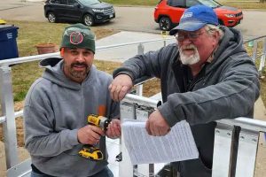 Two male Habitat volunteers working on a ramp as a home revitalization project